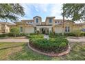 Two-story condo building with manicured landscaping at 1372 Emerald Dunes Dr, Sun City Center, FL 33573