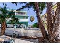 Side yard with white fence and view of neighboring building at 141 94Th Ave, Treasure Island, FL 33706