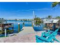 Private dock with boat lift and seating area overlooking the water at 410 140Th E Ave, Madeira Beach, FL 33708