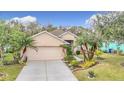 House exterior showcasing a two-car garage and nicely landscaped yard at 5122 Creekside Trl, Sarasota, FL 34243