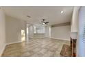 Open living room with a fireplace and tile flooring at 7404 Mint Julep Dr, Riverview, FL 33569