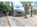 House exterior with palm trees, a paved driveway, and a well-maintained front yard at 4042 Boulder Dr, New Port Richey, FL 34653