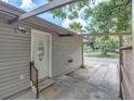Side view showing exterior access and a carport at 4042 Boulder Dr, New Port Richey, FL 34653