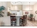 Kitchen with breakfast bar, appliances, and dining area at 4166 Central Sarasota Pkwy # 521, Sarasota, FL 34238