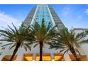 Modern high-rise building with palm trees at the entrance at 450 Knights Run Ave # 1102, Tampa, FL 33602