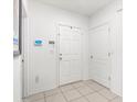 Bright entryway with white walls, tile flooring, and a conveniently placed key holder at 5193 Deltona Blvd, Spring Hill, FL 34606