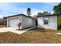 Charming single-story home with a well-maintained lawn, attached garage, and inviting front entrance at 5193 Deltona Blvd, Spring Hill, FL 34606