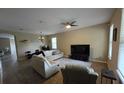 Spacious living room with tile flooring, a ceiling fan, and plenty of natural light at 8451 Karpeal Dr, Sarasota, FL 34238