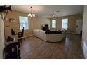 Bright living room with tile flooring, natural light, and an open layout at 8451 Karpeal Dr, Sarasota, FL 34238
