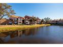 Scenic view of apartment buildings by the water, reflecting in the calm pond at 10200 Gandy N Blvd # 1313, St Petersburg, FL 33702