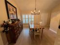 Bright dining room with hardwood floors, chandelier, and built-in hutch at 3638 Trafalgar Way # 102, Palm Harbor, FL 34685