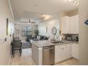 Modern kitchen with white cabinets and granite countertops at 4221 W Spruce St # 2418, Tampa, FL 33607