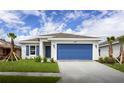Curb appeal of a one-story home with a blue garage door at 479 Winwood Ct, Port Charlotte, FL 33954