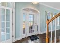 Bright entryway with a view of the water, hardwood floors, and classic design at 55 Edgewater Dr, Dunedin, FL 34698
