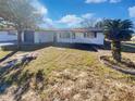 Newly renovated home with white exterior and landscaping at 7824 Hawthorn Dr, Port Richey, FL 34668