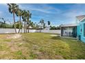 Large grassy backyard with screened porch at 815 Lantana Ave, Clearwater Beach, FL 33767