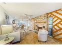 Living room with stone fireplace and built-in shelving at 13211 111Th Ln, Largo, FL 33778