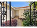 Inviting entryway with landscaped walkway and decorative iron gate at 1998 Massachusetts Ne Ave, St Petersburg, FL 33703