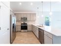 Modern kitchen featuring stainless steel appliances and white quartz countertops at 20118 Quesada Ave, Port Charlotte, FL 33952