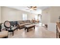 Living room with brown leather couch, coffee table, and ceiling fan at 3007 56Th S St, Gulfport, FL 33707