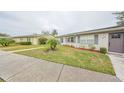 Charming one-story home exterior with well-maintained landscaping and gray shutters at 302 Canton Ct # 56, Sun City Center, FL 33573