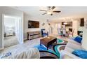Open concept living area with comfortable seating and large TV at 16847 Whisper Elm St, Wimauma, FL 33598