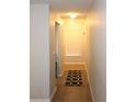 Bright hallway with wood-look floors and a window allowing natural light at 37715 Aaralyn Rd, Zephyrhills, FL 33542