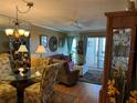 Bright living room with dining area and access to a balcony at 4908 38Th S Way # 504, St Petersburg, FL 33711