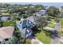 Beautiful aerial view of the home's backyard, canal, and surrounding neighborhood with mature landscaping at 5004 W Leona St, Tampa, FL 33629