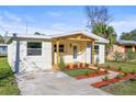 Cozy one-story house featuring a covered porch and inviting curb appeal at 712 E Madison St, Plant City, FL 33563