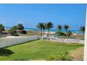 Oceanfront view from condo with lush landscaping and boardwalk access at 12000 Gulf Blvd # 208-S, Treasure Island, FL 33706