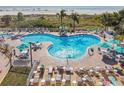 An inviting resort-style pool with plenty of lounge chairs and umbrellas at 12000 Gulf Blvd # 208-S, Treasure Island, FL 33706