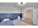 Small bedroom with blue wainscoting, a full-size bed, and French doors at 12783 Maple Bonsai Dr, Riverview, FL 33579