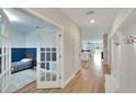 Bright entryway with hardwood floors, built-in bench, and French doors at 12783 Maple Bonsai Dr, Riverview, FL 33579