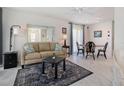 Living and dining area with a sofa, dining table, and tiled floor at 2740 Highlands Blvd # D, Palm Harbor, FL 34684
