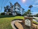 Harbor Bluffs community condo building with landscaping at 55 Harbor View Ln # 108, Belleair Bluffs, FL 33770