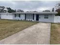 Newly renovated 1950s home with gray exterior, new landscaping, and a long driveway at 5700 38Th N Ave, St Petersburg, FL 33710