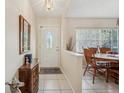 Bright entryway with a charming wooden console table and dining area at 6103 E 112Th Ave, Temple Terrace, FL 33617