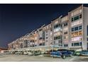 Condo building with parking at night at 634 Edgewater Dr # 447, Dunedin, FL 34698