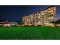 Night view of condo building with lush landscaping at 634 Edgewater Dr # 447, Dunedin, FL 34698