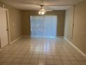 Living room with tile flooring and sliding glass doors at 7519 Pitch Pine Cir # 171, Tampa, FL 33617