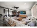 Spacious living room with sectional sofa, large TV, and hardwood floors at 8390 64Th N St, Pinellas Park, FL 33781