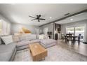 Open living space with sectional sofa, coffee table, and adjacent dining area at 8390 64Th N St, Pinellas Park, FL 33781