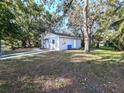 Spacious backyard with mature trees and grassy lawn at 12306 Mitchell St, Tampa, FL 33612