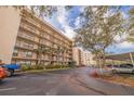 Exterior view of condo building with parking and landscaping at 1316 Pasadena S Ave # 203, South Pasadena, FL 33707