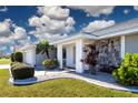 House exterior with stone accents and lush landscaping at 1812 Wedge Ct, Sun City Center, FL 33573