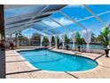 A beautiful, screened pool overlooks the canal, with plenty of space to relax at 224 7Th E St, Tierra Verde, FL 33715