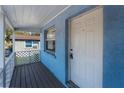 White door and lattice detailing on a light blue house at 2418 N Links Ave, Sarasota, FL 34234