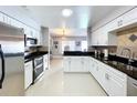 Modern kitchen featuring white cabinets, stainless steel appliances, and dark countertops at 3004 Rosebud Ln, Brandon, FL 33511