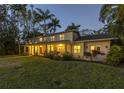 Exterior of a home on a corner lot, illuminated at twilight, highlighting its architecture at 323 Coffee Pot Ne Dr, St Petersburg, FL 33704